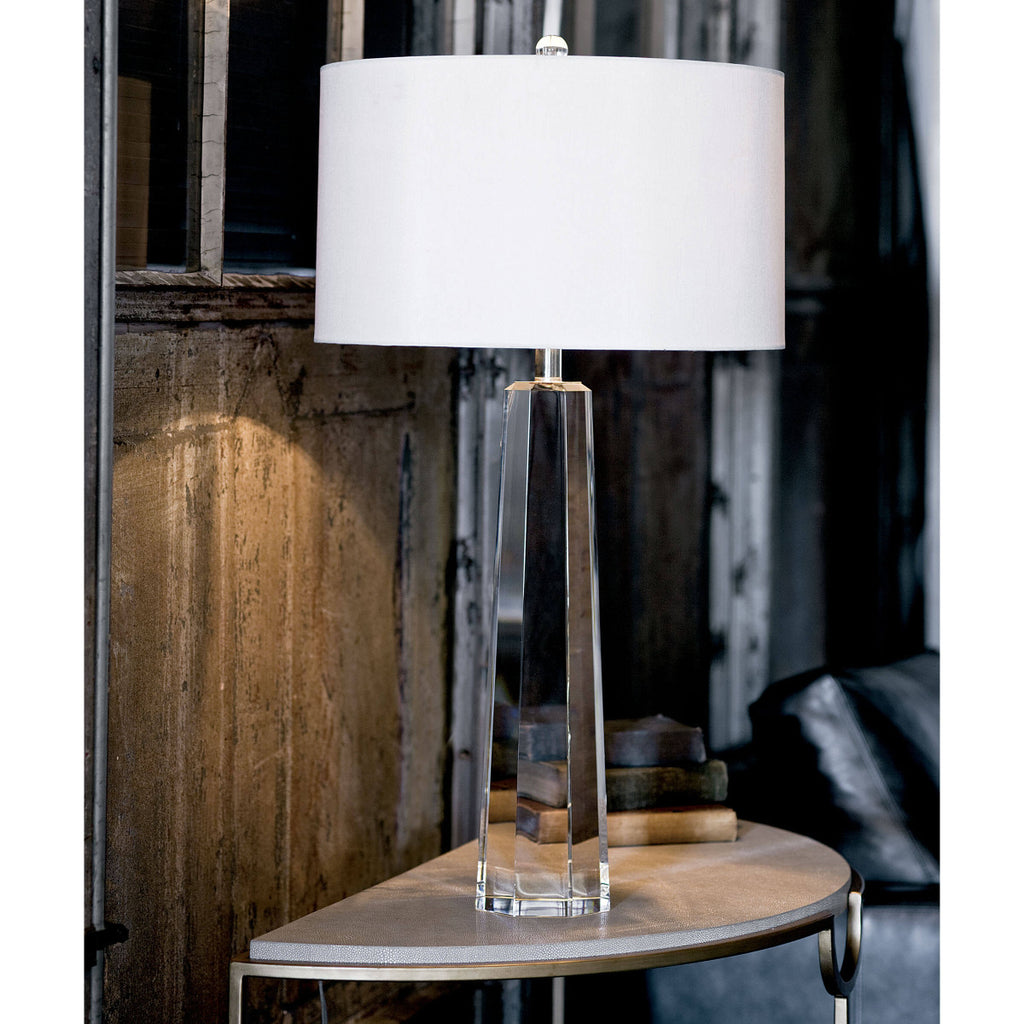 clear table lamp sitting on end table