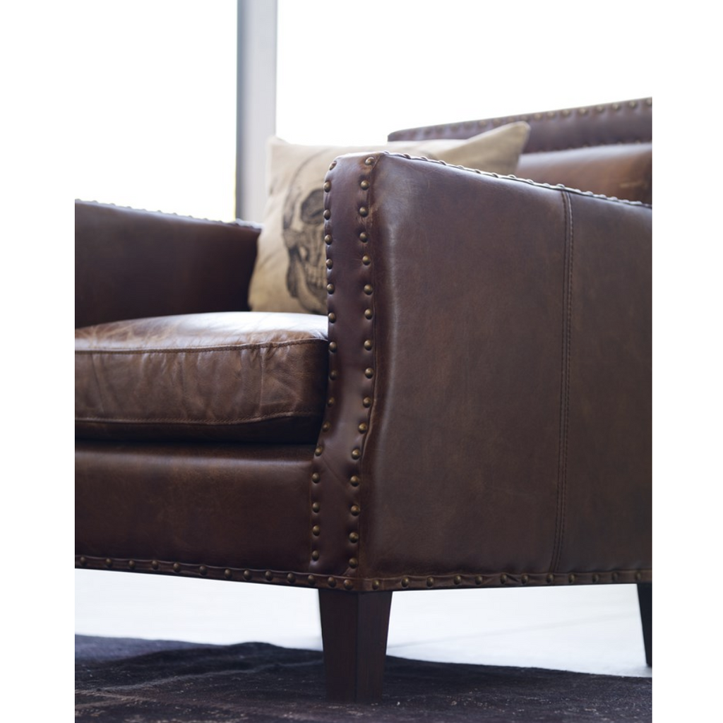 brown leather arm chair with brass nailhead details