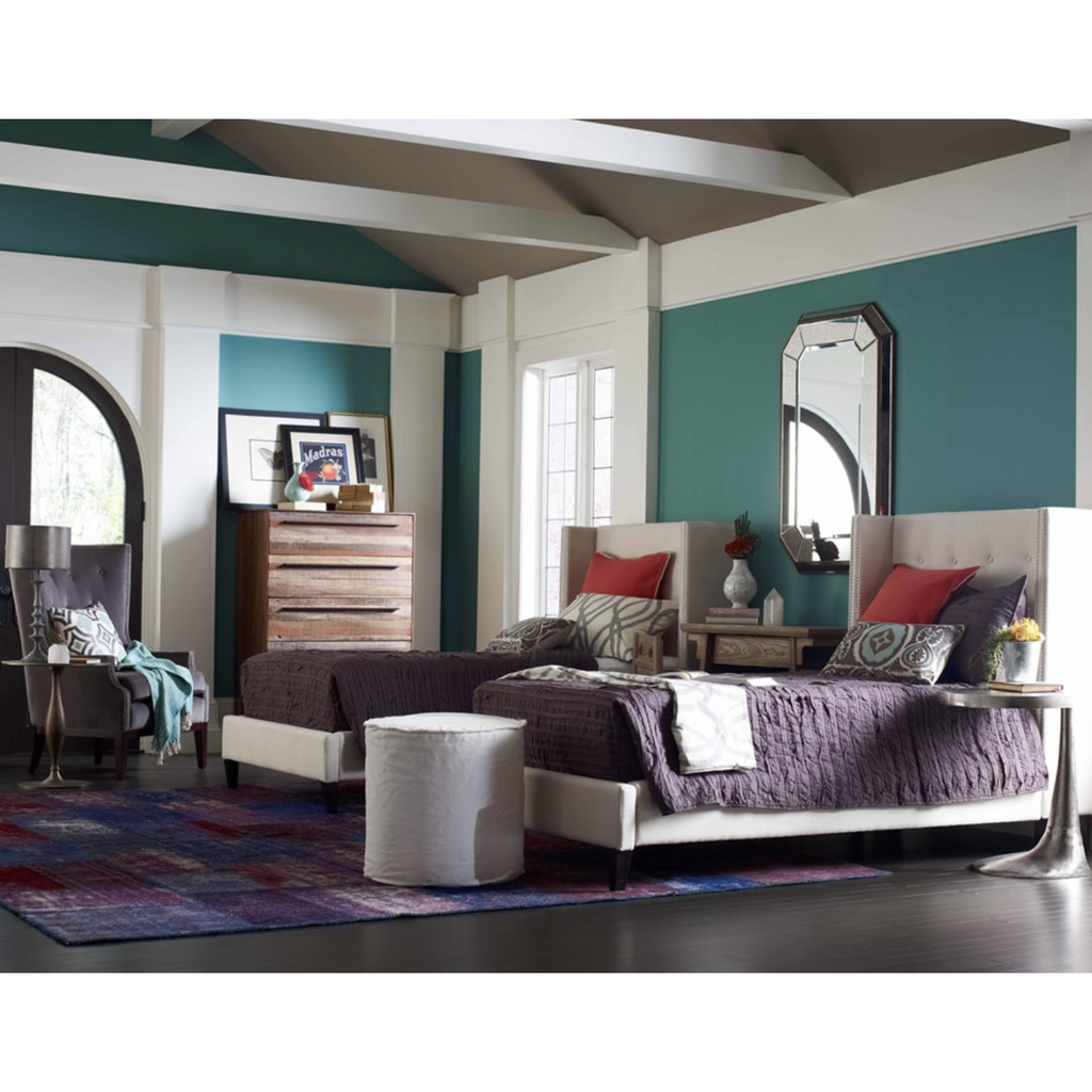 colorful bedroom with grey velvet chair
