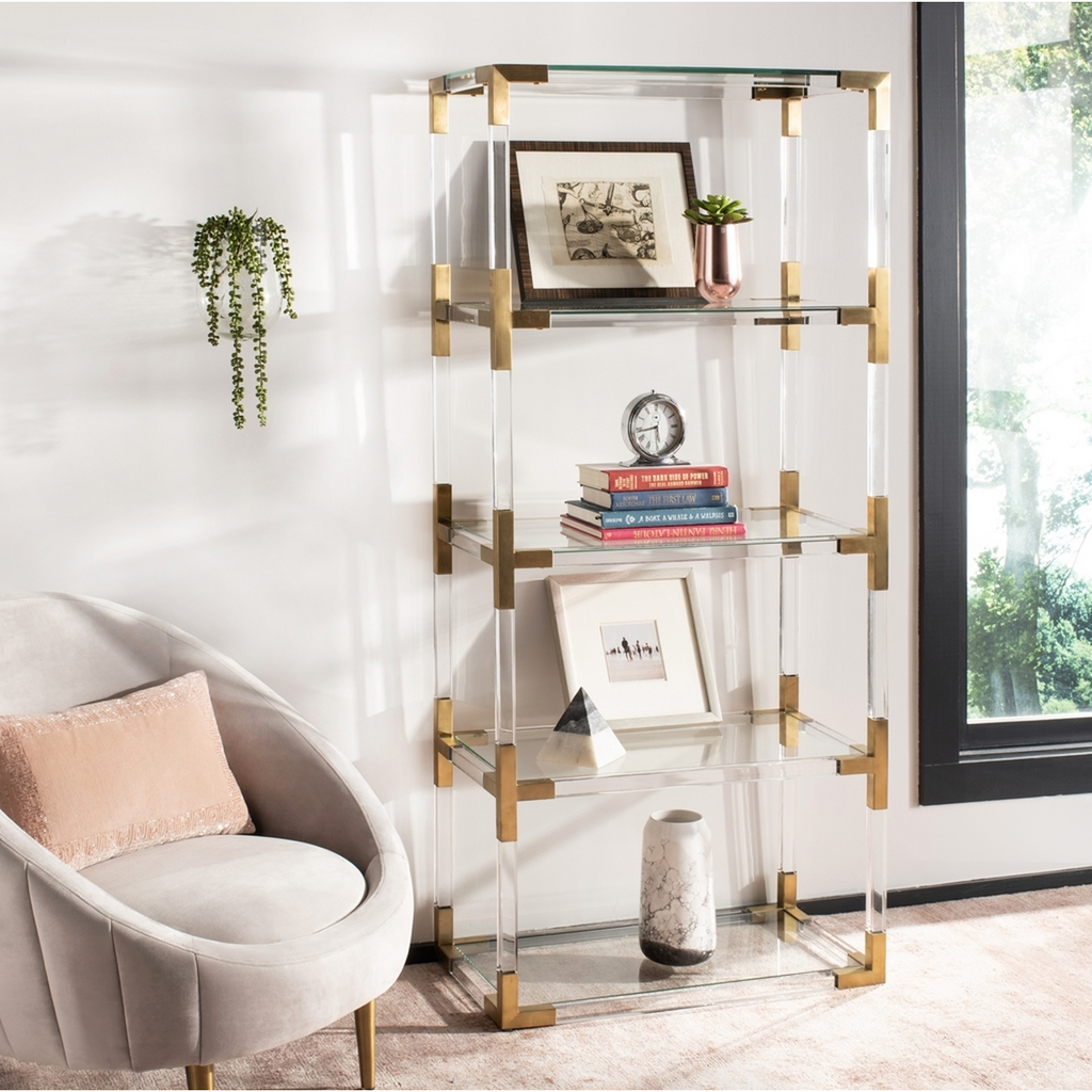 acrylic and brass bookshelf in sitting area