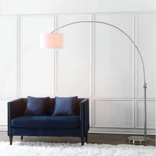 ascella arc floor lamp above blue couch turned on